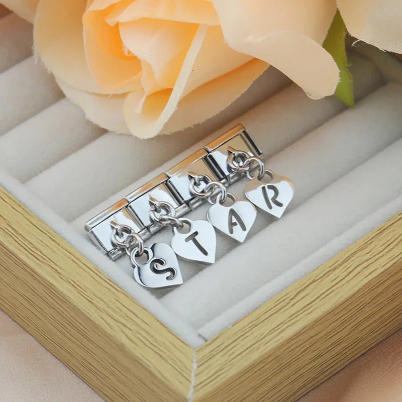 Letter charms spelling STAR